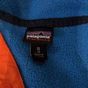 Blue, navy, and orange Patagonia 1/2 zip sweatshirt.